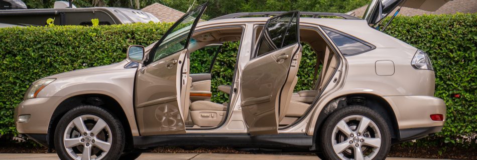 Photographic capture of a Lexus SUV, emphasizing its metallic sheen and sleek lines, taken by Osiel Garrett